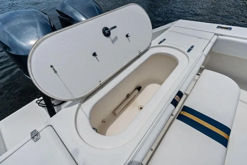 Slide: The Image of 1997 Venture 34 Center Console boat with open storage compartment and dual engines. - 29
