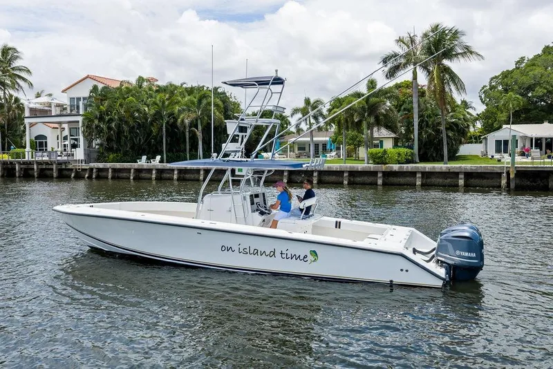Slide: The Image of 1997 Venture 34 Center Console boat on water, labeled "on island time," with Yamaha engine. - 3