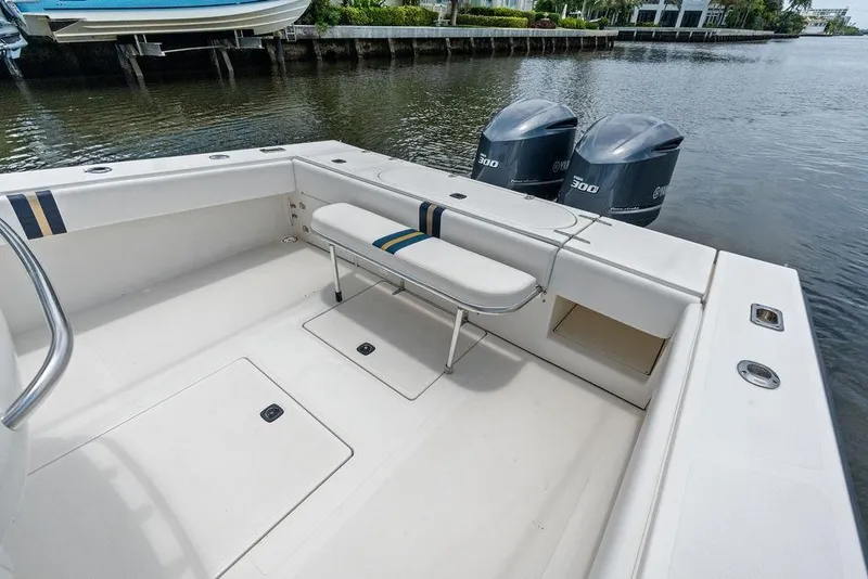 Slide: The Image of 1997 Venture 34 Center Console boat with twin Yamaha 300 engines, docked by the water. - 30