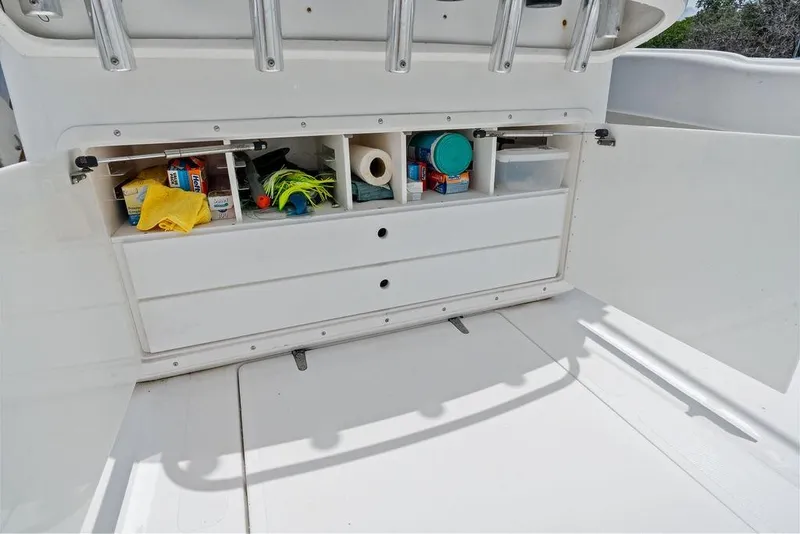 Slide: The Image of Storage compartments on a 1997 Venture 34 Center Console boat, stocked with supplies. - 32