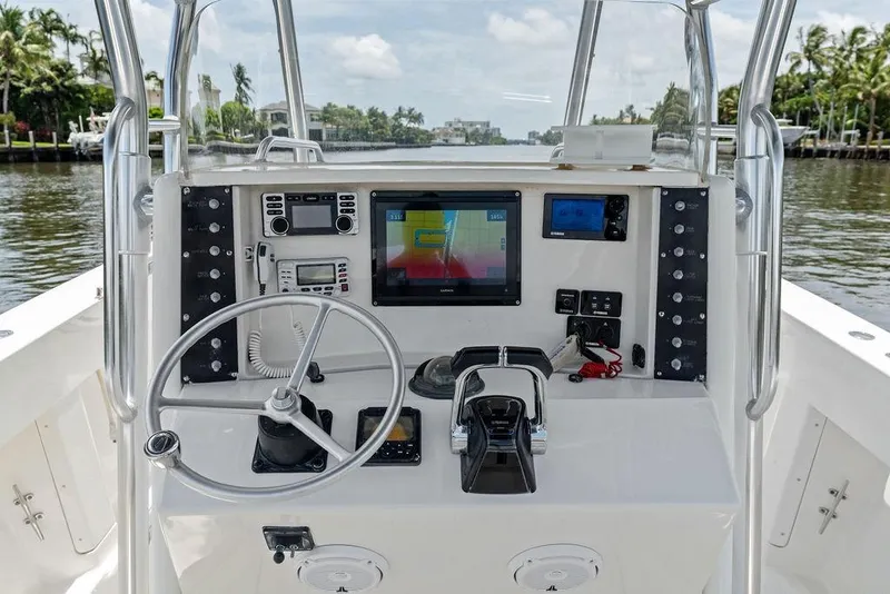 Slide: The Image of Center console of a 1997 Venture 34 boat with navigation equipment and steering wheel. - 34