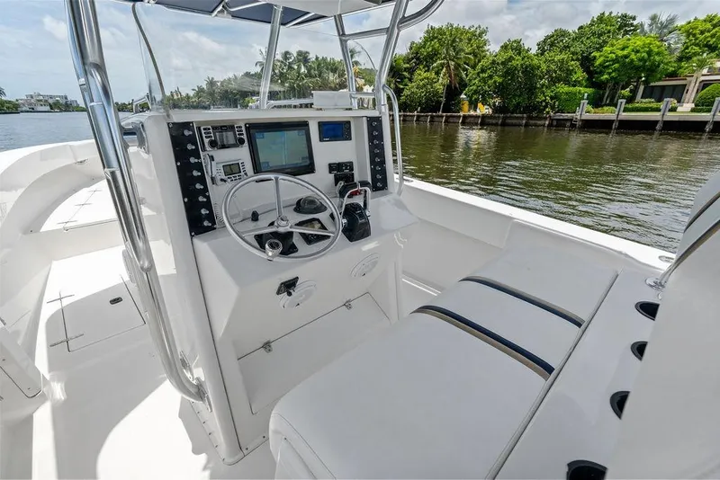 Slide: The Image of 1997 Venture 34 Center Console boat interior with steering wheel and navigation equipment. - 35