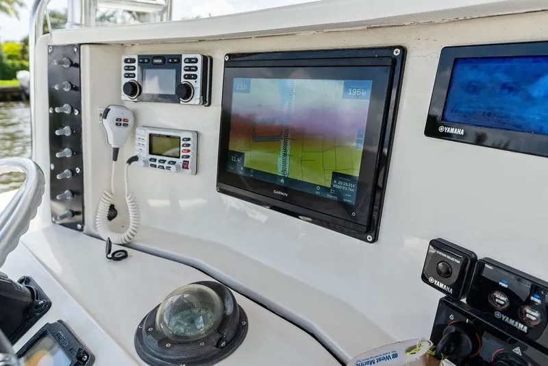 Slide: The Image of 1997 Venture 34 Center Console dashboard with navigation and communication equipment. - 38