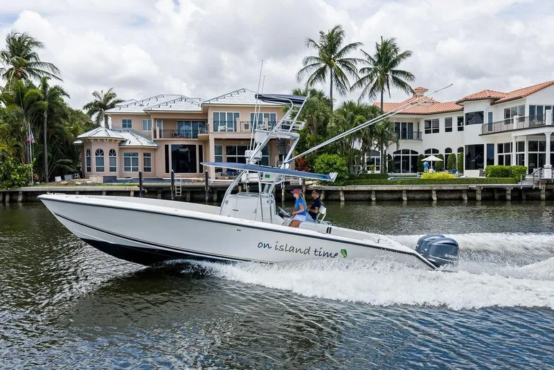 Slide: The Image of 1997 Venture 34 Center Console boat cruising near waterfront homes, palm trees in background. - 4