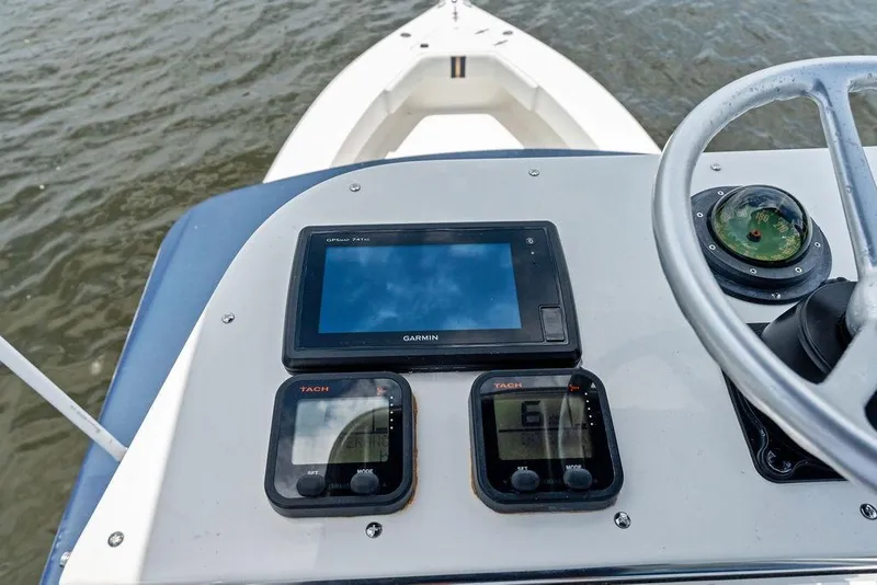 Slide: The Image of Center console of a 1997 Venture 34 boat with Garmin GPS and tachometers. - 41