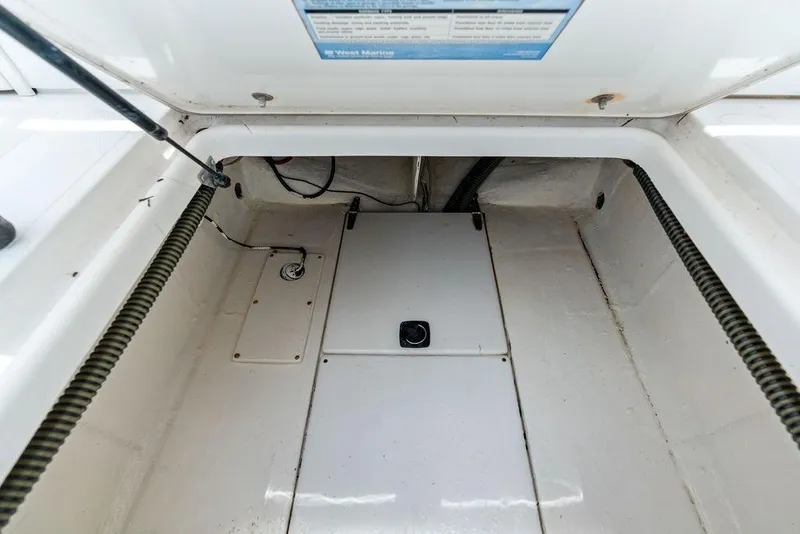Slide: The Image of Interior view of a 1997 Venture 34 Center Console boat compartment, showcasing storage space. - 44