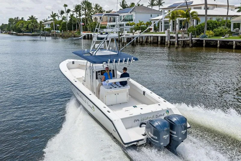 Slide: The Image of 1997 Venture 34 Center Console boat cruising on a scenic waterway. - 7