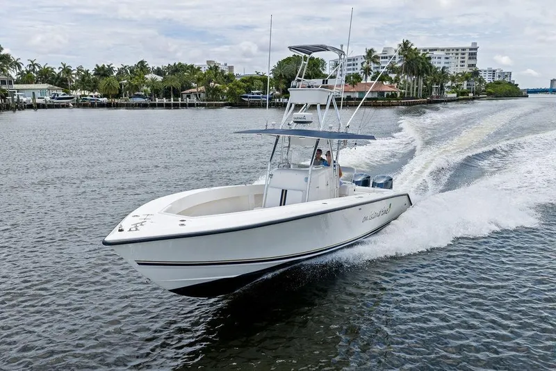 Slide: The Image of 1997 Venture 34 Center Console boat cruising on a scenic waterway. - 9