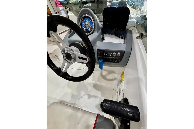 Slide: The Image of 2020 Tahoe T16 boat dashboard with steering wheel and control panel. - 11