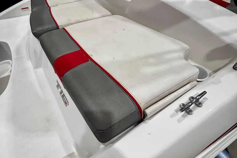 Slide: The Image of 2020 Tahoe T16 boat seat with red and gray accents, featuring a cleat. - 14
