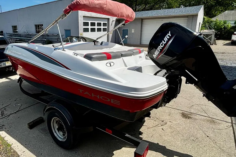 Slide: The Image of 2020 Tahoe T16 boat with Mercury engine on trailer, parked outdoors. - 4