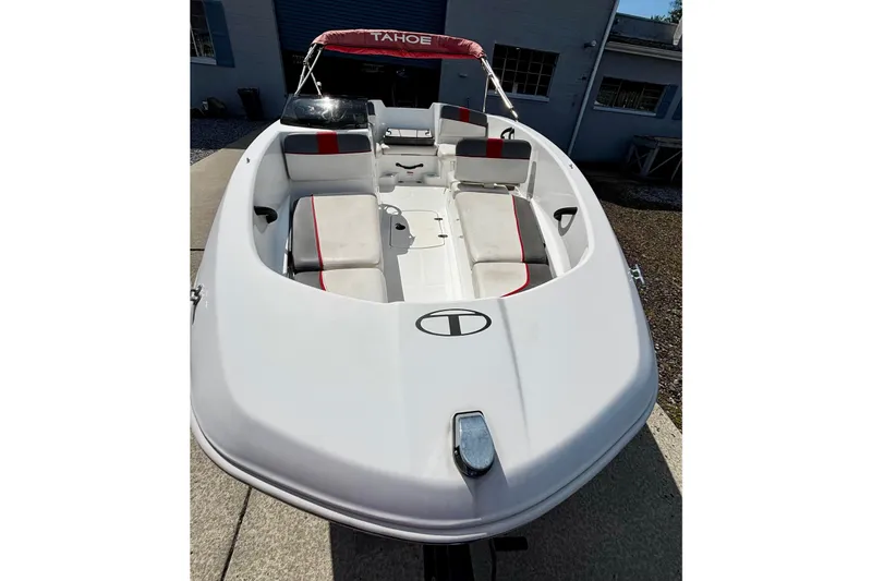 Slide: The Image of 2020 Tahoe T16 boat with white and red interior, docked outdoors. - 6
