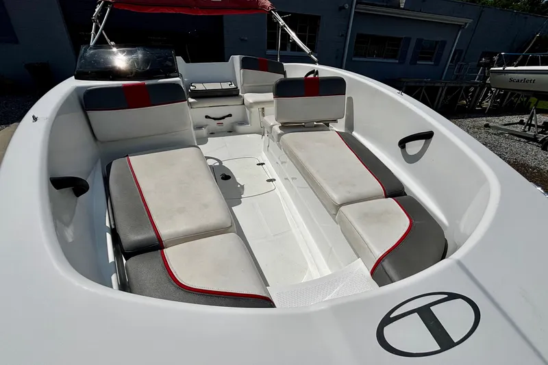 Slide: The Image of 2020 Tahoe T16 boat interior with cushioned seating and red accents. - 7