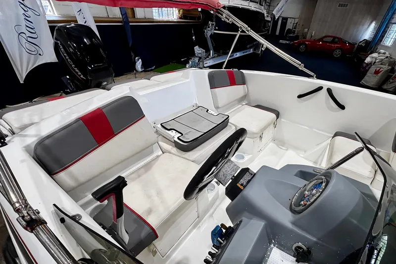 Slide: The Image of Interior of a 2020 Tahoe T16 boat with seating and steering console. - 8