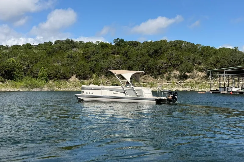 Slide: The Image of 2017 Avalon Catalina Platinum 2585 pontoon boat on a scenic lake. - 16