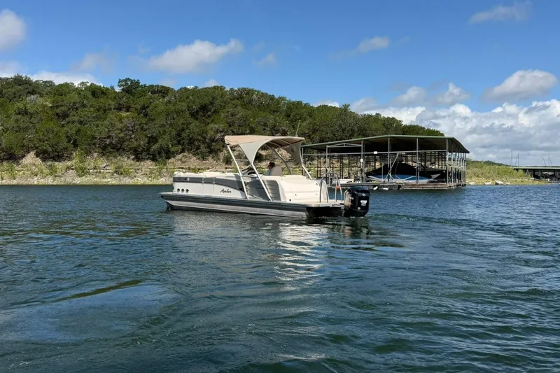 Slide: The Image of 2017 Avalon Catalina Platinum 2585 pontoon boat on a scenic lake. - 17