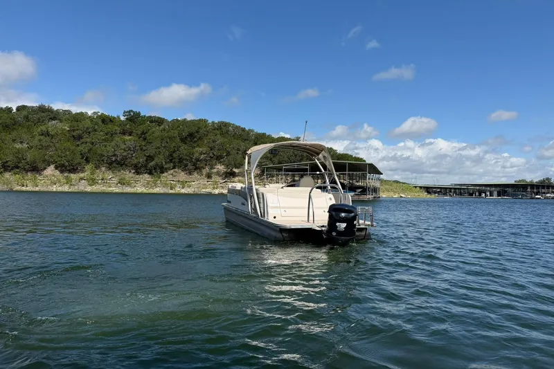 Slide: The Image of 2017 Avalon Catalina Platinum 2585 pontoon boat on a scenic lake. - 18