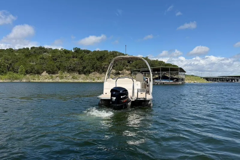 Slide: The Image of 2017 Avalon Catalina Platinum 2585 pontoon boat cruising on a scenic lake. - 19