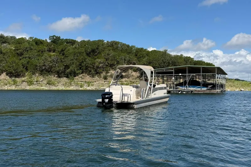 Slide: The Image of 2017 Avalon Catalina Platinum 2585 pontoon boat on a scenic lake with dock and trees. - 20