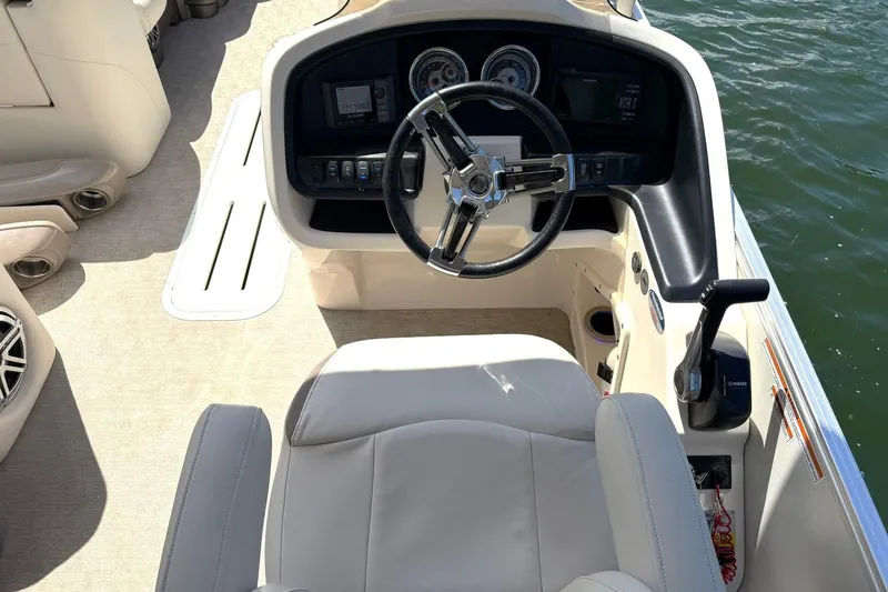 Slide: The Image of 2017 Avalon Catalina Platinum 2585 boat cockpit with steering wheel and controls. - 3