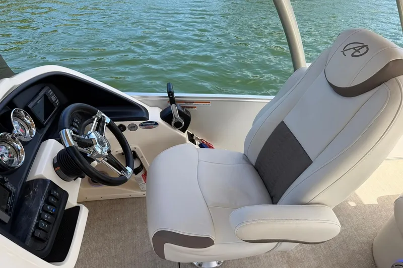Slide: The Image of 2017 Avalon Catalina Platinum 2585 boat interior with steering wheel and captain's chair. - 30