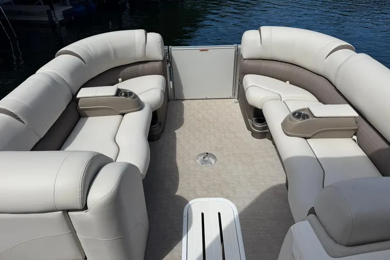Slide: The Image of Luxurious seating on 2017 Avalon Catalina Platinum 2585 pontoon boat, docked on calm water. - 38