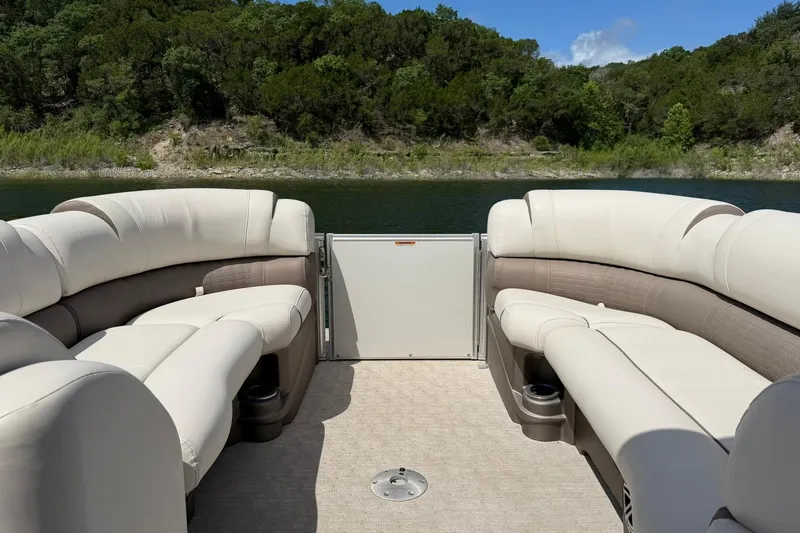 Slide: The Image of 2017 Avalon Catalina Platinum 2585 pontoon boat interior with plush seating on a serene lake. - 39