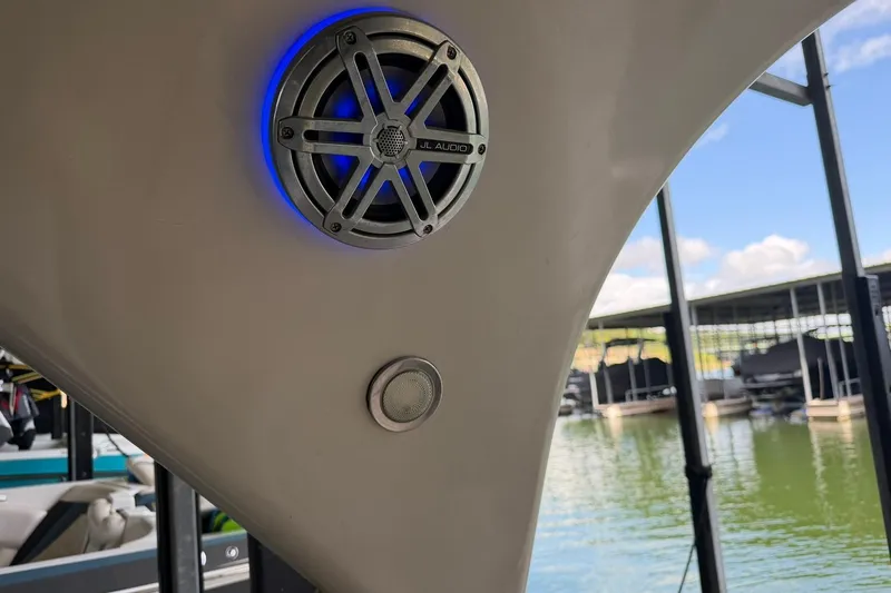 Slide: The Image of Speaker on 2017 Avalon Catalina Platinum 2585 boat, docked by a serene lake. - 43