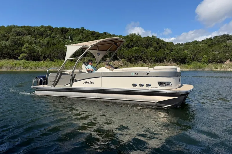 Slide: The Image of 2017 Avalon Catalina Platinum 2585 pontoon boat cruising on a scenic lake. - 7