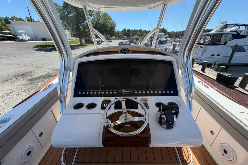 Slide: The Image of 2021 Valhalla Boatworks V-33 helm with modern controls and sleek design at marina. - 12