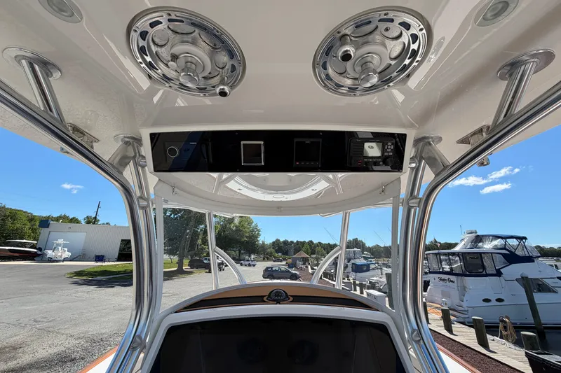 Slide: The Image of Interior view of 2021 Valhalla Boatworks V-33, showcasing helm and overhead speakers. - 13