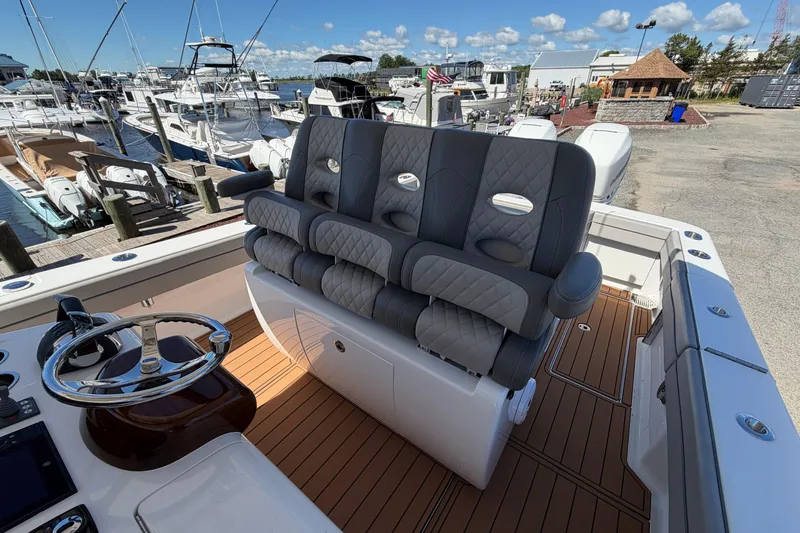 Slide: The Image of Luxurious 2021 Valhalla Boatworks V-33 helm seating with elegant design at a marina. - 15