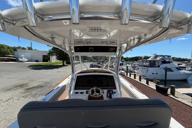 Slide: The Image of 2021 Valhalla Boatworks V-33 helm view at marina, showcasing sleek design and controls. - 17