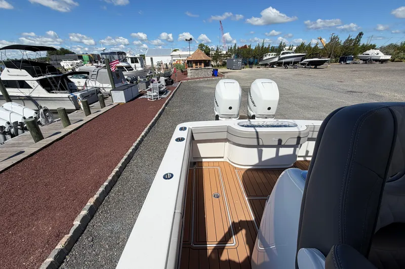 Slide: The Image of 2021 Valhalla Boatworks V-33 at marina with twin engines and wooden deck. - 18