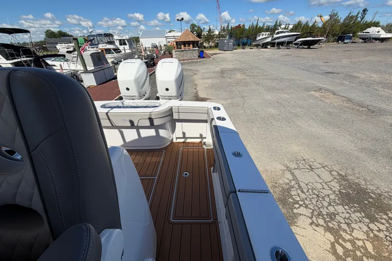 Slide: The Image of 2021 Valhalla Boatworks V-33 with dual engines, docked in a marina under a clear sky. - 19