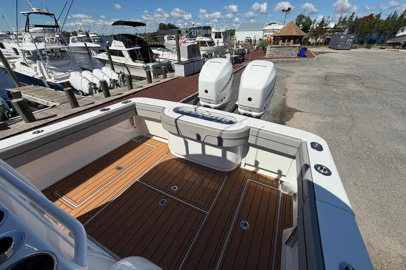 Slide: The Image of 2021 Valhalla Boatworks V-33 with twin engines, docked at a marina under a clear sky. - 22