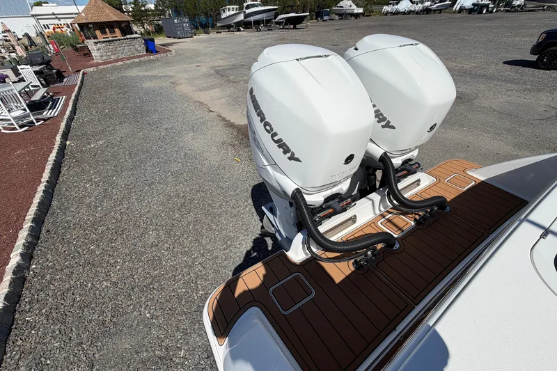 Slide: The Image of 2021 Valhalla Boatworks V-33 with dual Mercury outboard engines on a wooden deck. - 23