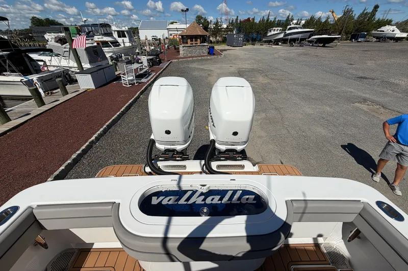 Slide: The Image of 2021 Valhalla Boatworks V-33 with dual outboard engines at a marina. - 28