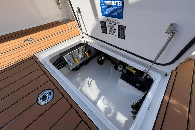 Slide: The Image of 2021 Valhalla Boatworks V-33 storage compartment with mechanical components and teak flooring. - 29