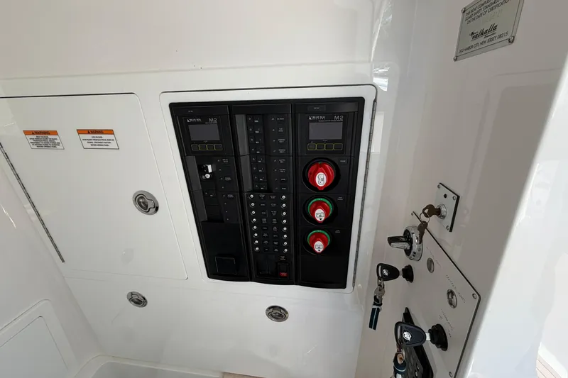 Slide: The Image of 2021 Valhalla Boatworks V-33 electrical panel with switches and controls. - 31