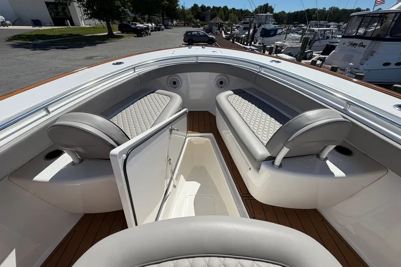 Slide: The Image of 2021 Valhalla Boatworks V-33 interior with cushioned seating and storage compartment. - 8