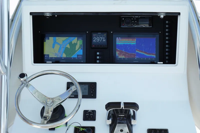 Slide: The Image of 2015 Onslow Bay boat dashboard with navigation screens and steering wheel. - 12