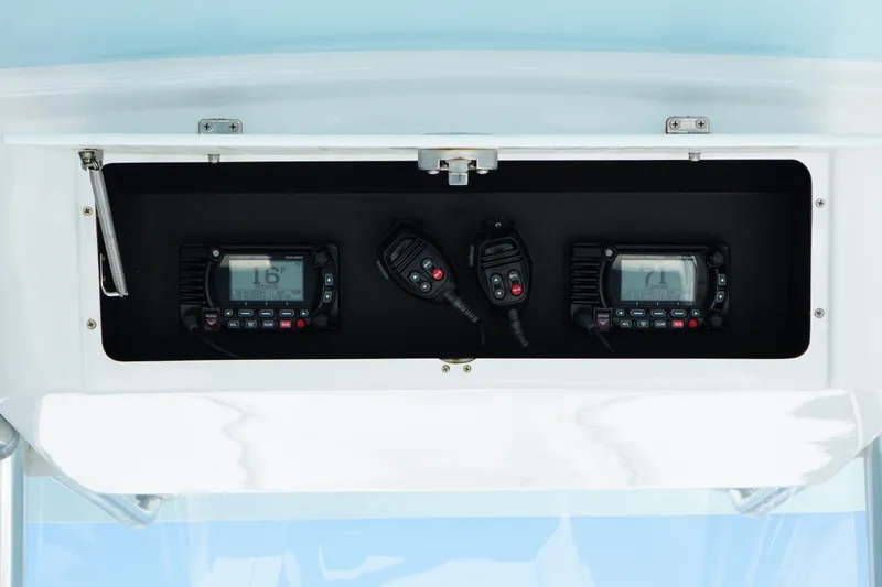 Slide: The Image of 2015 Onslow Bay boat electronics compartment with communication radios and microphones. - 13