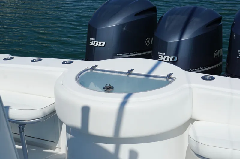 Slide: The Image of 2015 Onslow Bay boat with Yamaha 300 engines and livewell, docked on calm water. - 18