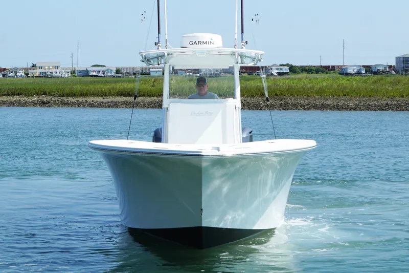 Slide: The Image of 2015 Onslow Bay boat cruising on calm water with coastal background. - 4