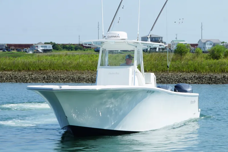 Slide: The Image of 2015 Onslow Bay boat cruising on calm water near grassy shoreline. - 5