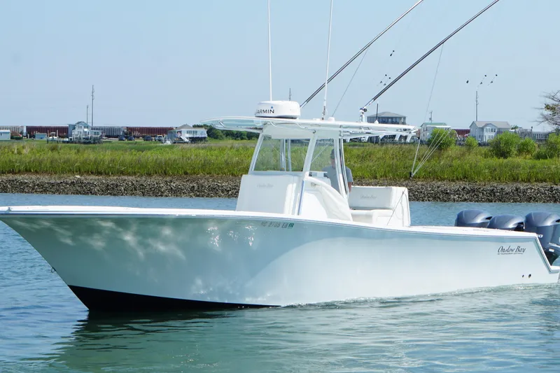 Slide: The Image of 2015 Onslow Bay boat cruising on calm water near grassy shoreline. - 6