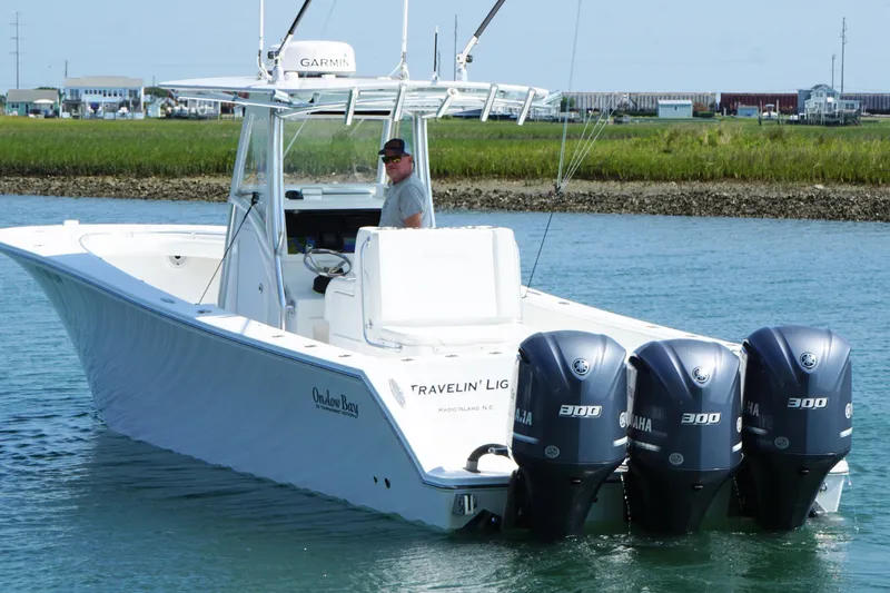 Slide: The Image of 2015 Onslow Bay boat with triple Yamaha 300 engines on calm water. - 7
