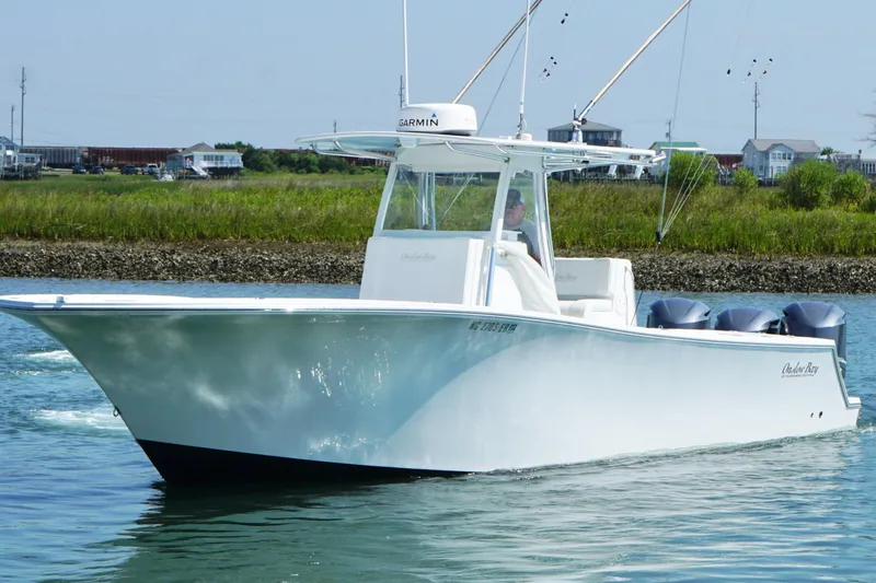 Slide: The Image of 2015 Onslow Bay boat cruising on calm water near a grassy shoreline. - 8