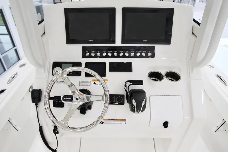 Slide: The Image of Helm of 2027 Regulator 24XO boat with steering wheel and control panel. - 2